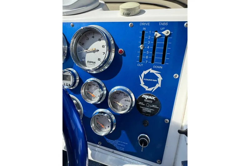 Slide: The Image of Control panel of a 2004 Fountain 27 Fever boat with gauges and switches. - 19