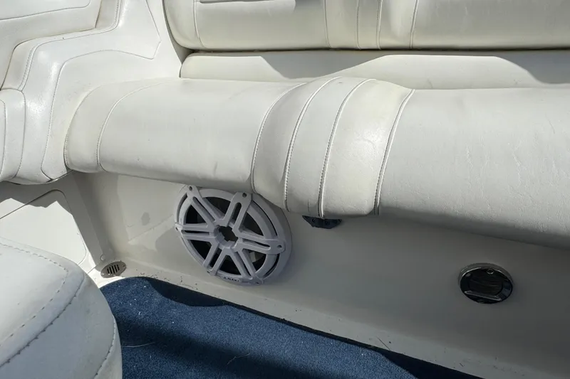 Slide: The Image of White leather seating and speaker in a 2004 Fountain 27 Fever boat interior. - 25