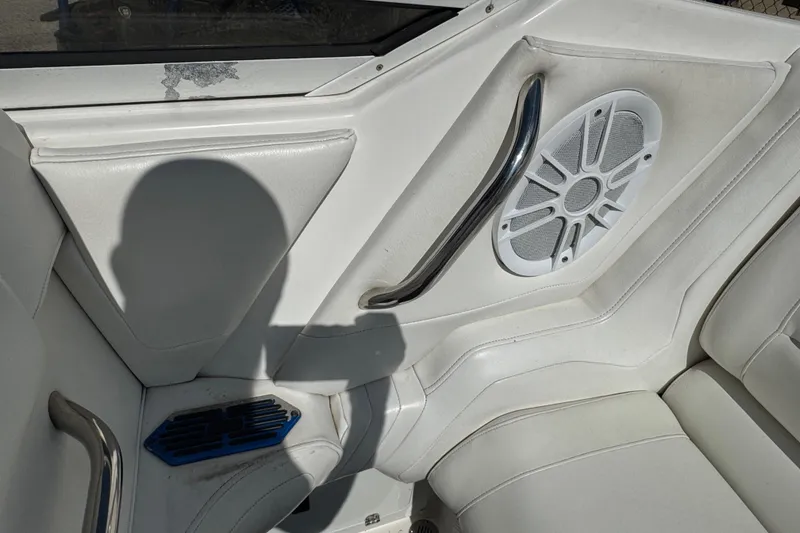 Slide: The Image of Interior of a 2004 Fountain 27 Fever boat with white seating and speaker. - 27