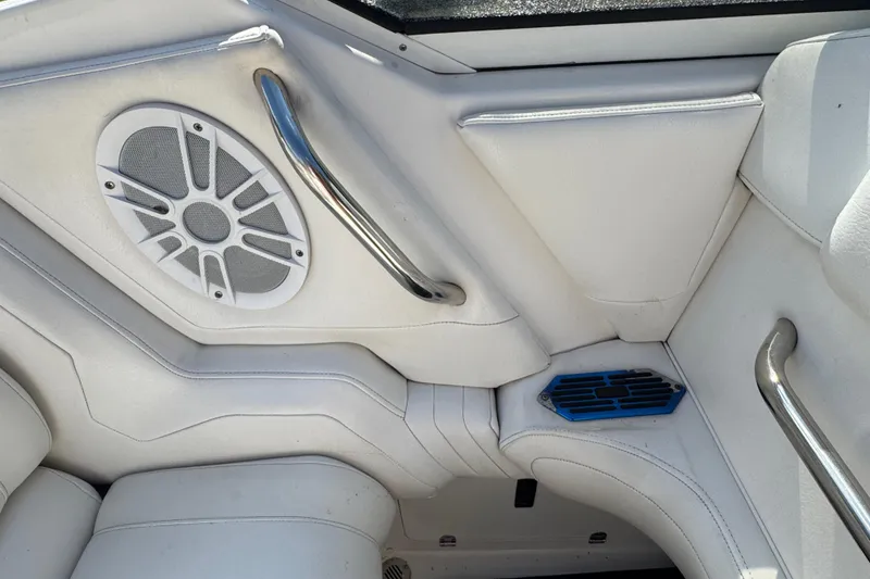 Slide: The Image of 2004 Fountain 27 Fever boat interior with white upholstery and speaker. - 28