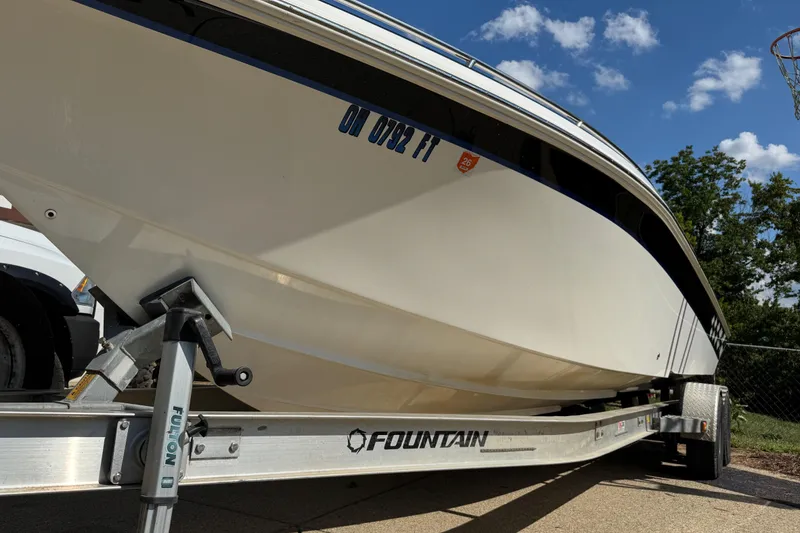 Slide: The Image of 2004 Fountain 27 Fever boat on trailer under blue sky. - 3