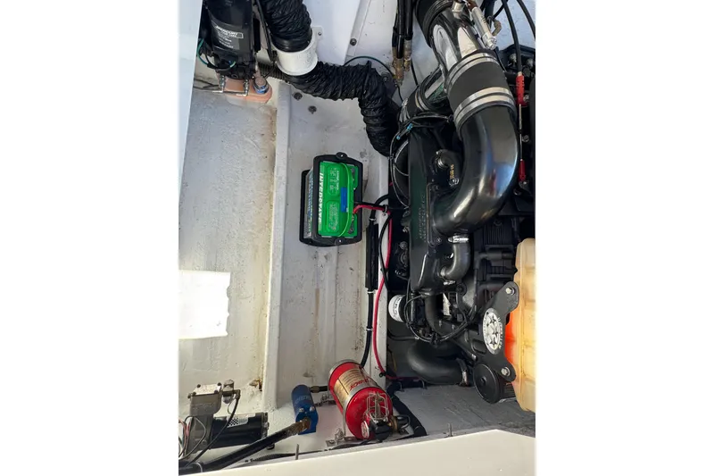 Slide: The Image of Engine compartment of a 2004 Fountain 27 Fever boat, featuring battery and components. - 30