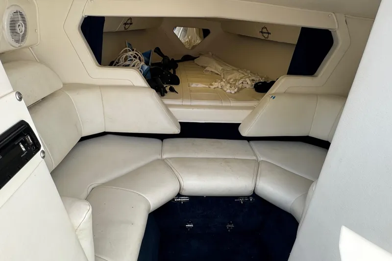 Slide: The Image of Interior of a 2004 Fountain 27 Fever boat with white seating and storage area. - 33