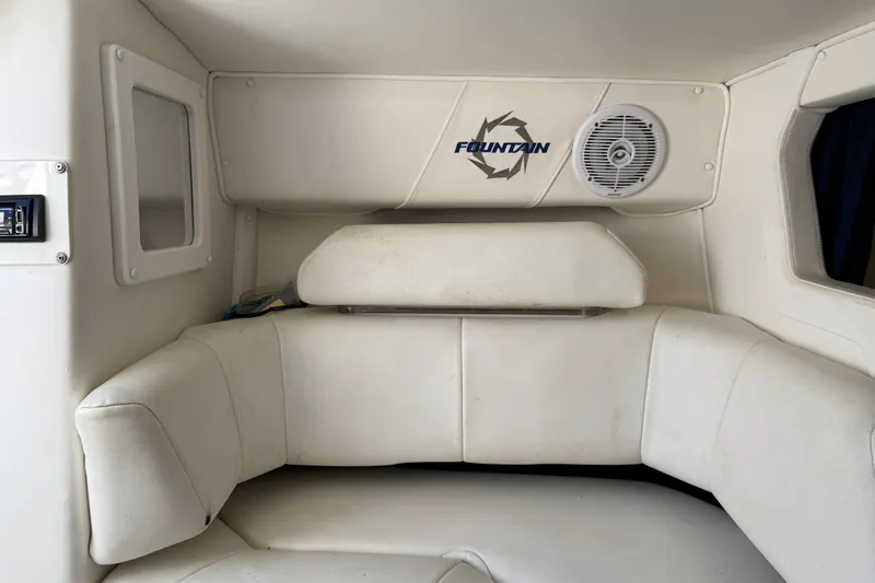 Slide: The Image of Interior of a 2004 Fountain 27 Fever boat with white seating and speaker. - 36