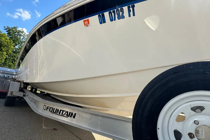 Slide: The Image of 2004 Fountain 27 Fever boat on trailer, showcasing sleek design and registration details. - 4