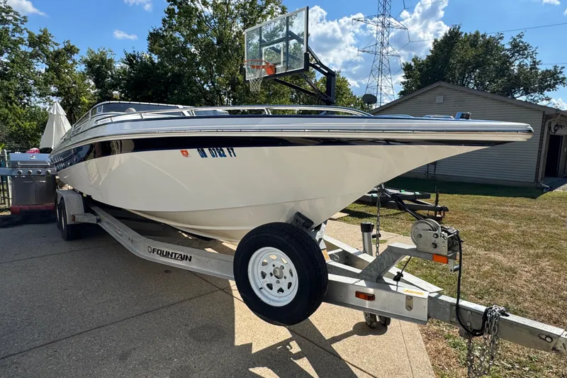 Slide: The Image of 2004 Fountain 27 Fever boat on trailer in driveway, sunny day. - 5