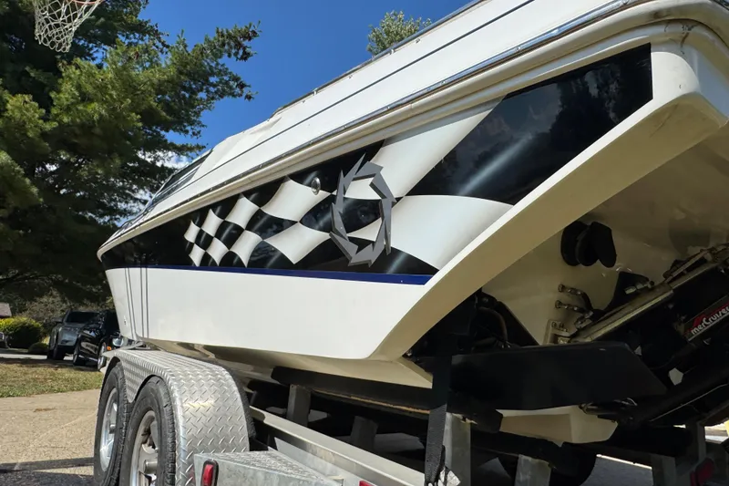 Slide: The Image of 2004 Fountain 27 Fever boat with checkered flag design on trailer. - 7