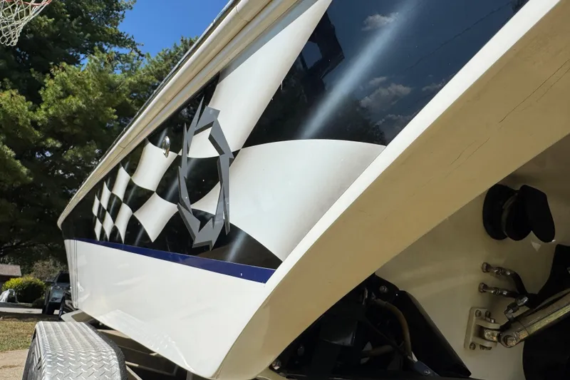 Slide: The Image of 2004 Fountain 27 Fever boat with checkered flag design on trailer. - 9