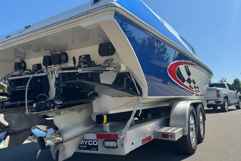 Slide: The Image of 2004 Fountain 35 Lightning boat on trailer, featuring dual engines and vibrant blue design. - 10