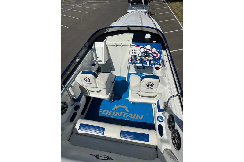Slide: The Image of 2004 Fountain 35 Lightning boat interior with blue accents and dual seating. - 13