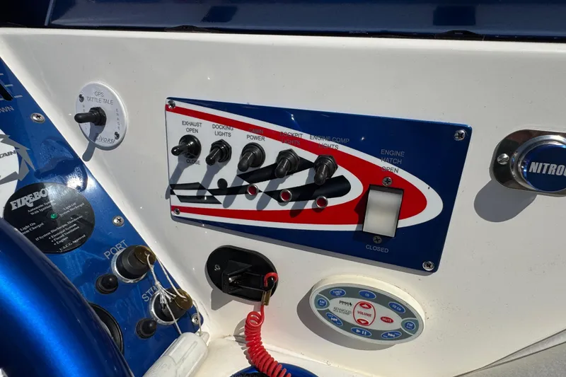 Slide: The Image of Control panel of a 2004 Fountain 35 Lightning boat with various switches and buttons. - 16