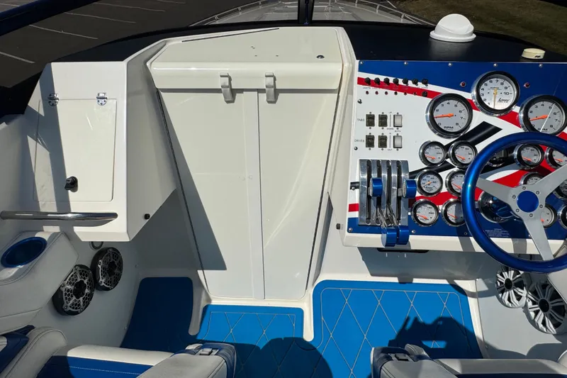 Slide: The Image of Cockpit of 2004 Fountain 35 Lightning boat with gauges, controls, and blue accents. - 17