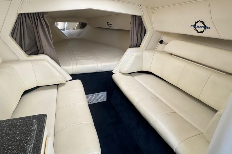 Slide: The Image of Interior of a 2004 Fountain 35 Lightning boat with cream leather seating and sleeping area. - 21