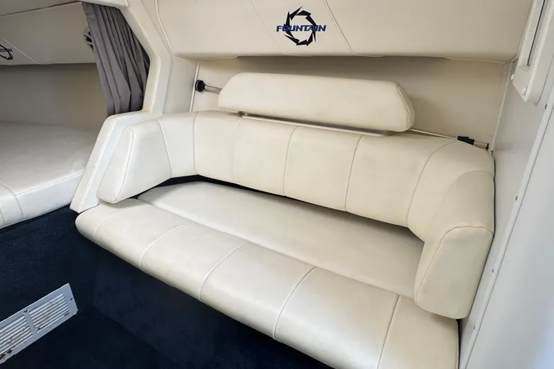 Slide: The Image of Interior seating of a 2004 Fountain 35 Lightning boat, featuring white upholstery. - 22