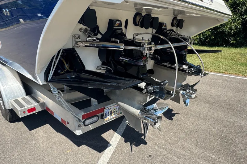 Slide: The Image of Rear view of a 2004 Fountain 35 Lightning boat on a trailer, showcasing dual propellers. - 4