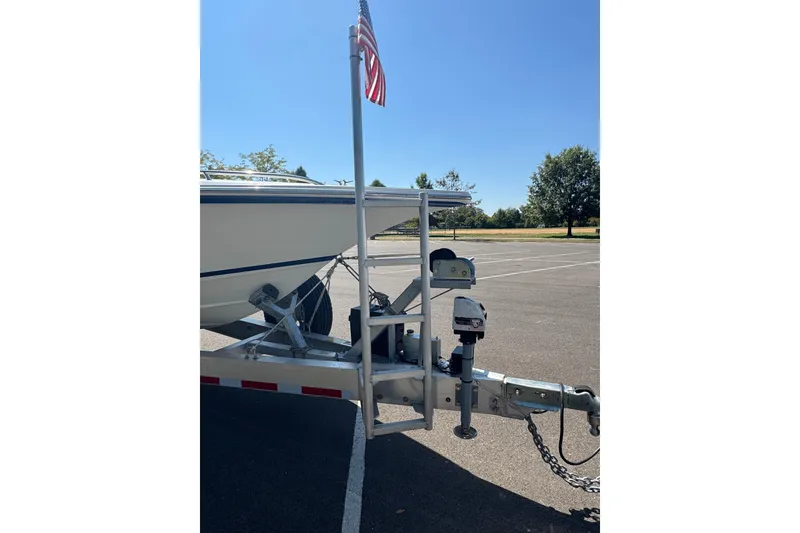 Slide: The Image of 2004 Fountain 35 Lightning boat on trailer with American flag in parking lot. - 7