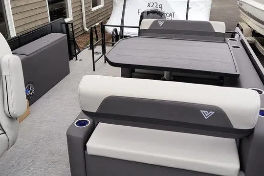 Slide: The Image of 2026 Viaggio X22D boat interior with gray seating and table, featuring modern design elements. - 9