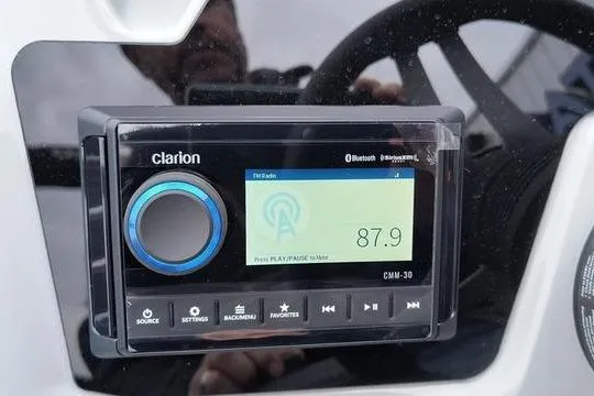 Slide: The Image of Clarion CMM-30 stereo system in Viaggio x22u, 2026 model, displaying FM radio frequency 87.9. - 6