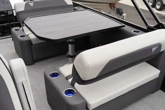 Slide: The Image of Luxurious seating area on 2026 Viaggio x22u boat with table and cup holders. - 9