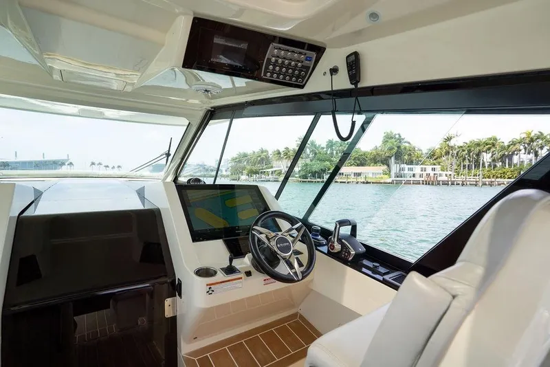 Slide: The Image of Interior view of 2020 Scout 530 LXF boat cockpit with steering wheel and navigation system. - 101