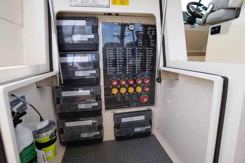 Slide: The Image of Electrical panel inside 2020 Scout 530 LXF boat, featuring switches and storage compartments. - 103