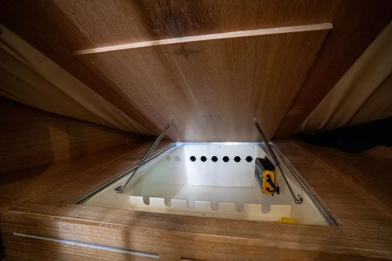 Slide: The Image of Under-seat storage compartment in 2020 Scout 530 LXF boat, featuring hydraulic lift. - 105