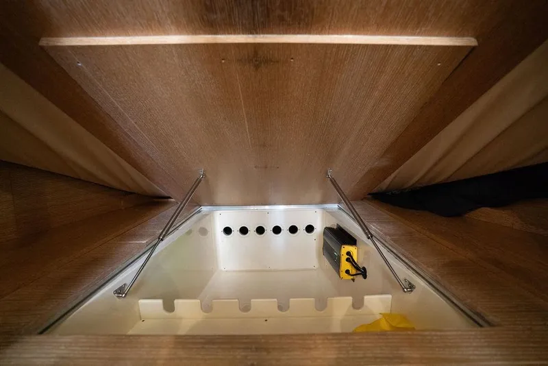 Slide: The Image of Interior storage compartment of 2020 Scout 530 LXF boat with wooden finish. - 107