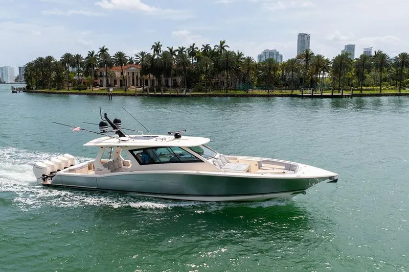 Slide: The Image of 2020 Scout 530 LXF yacht cruising near a tropical island with palm trees. - 11