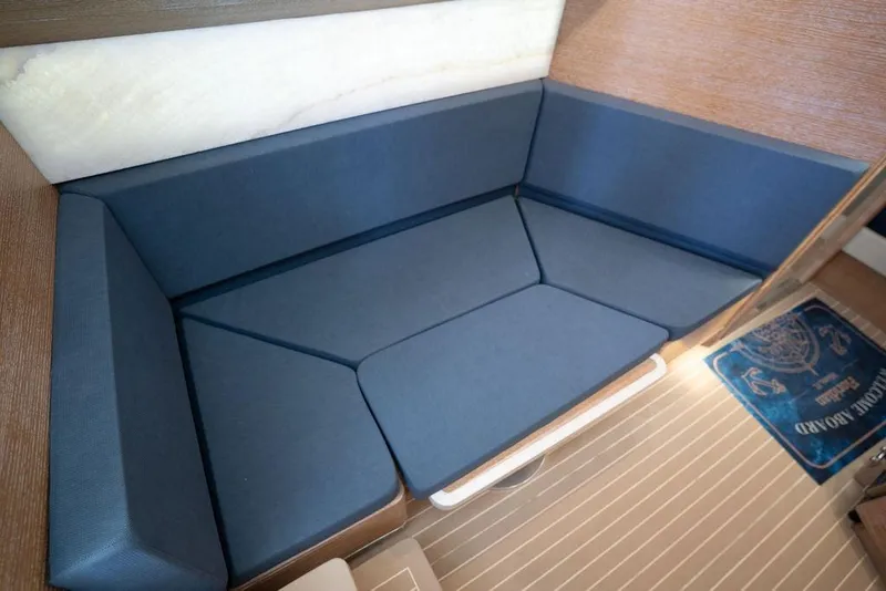 Slide: The Image of 2020 Scout 530 LXF interior seating with blue cushions and wooden flooring. - 112