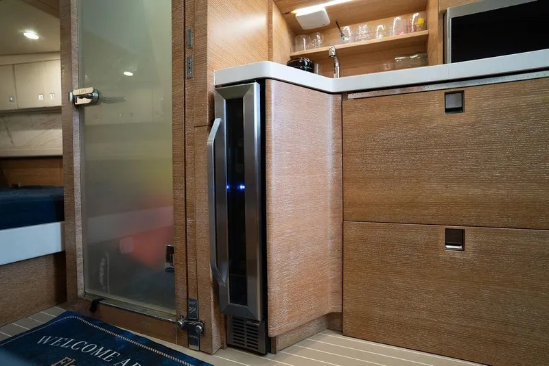 Slide: The Image of Interior of 2020 Scout 530 LXF yacht with modern kitchenette and storage. - 121