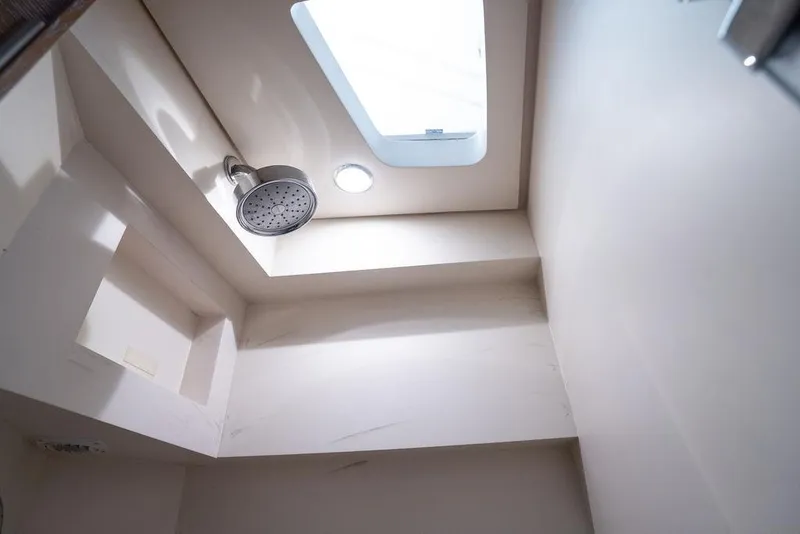 Slide: The Image of Interior shower view of 2020 Scout 530 LXF yacht with skylight and modern fixtures. - 125