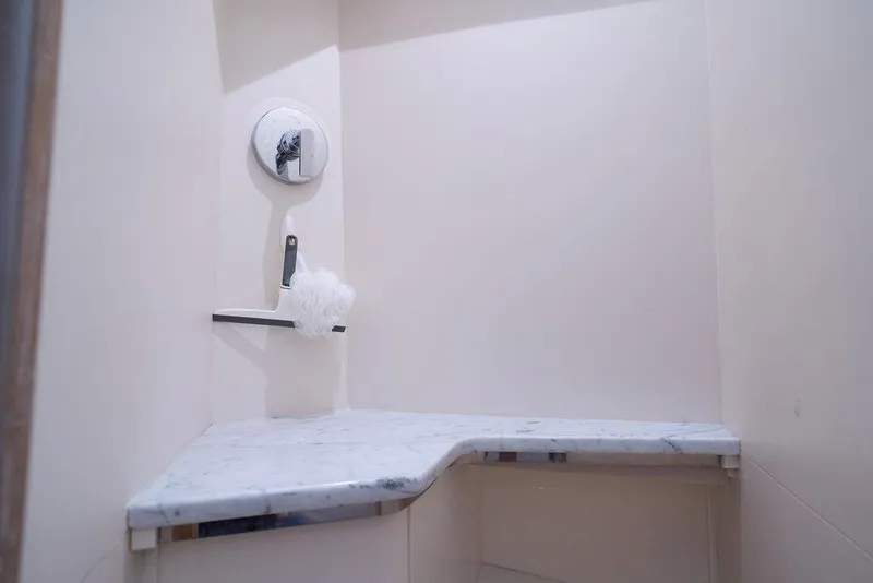 Slide: The Image of Luxurious shower area in 2020 Scout 530 LXF yacht with marble bench and modern fixtures. - 126
