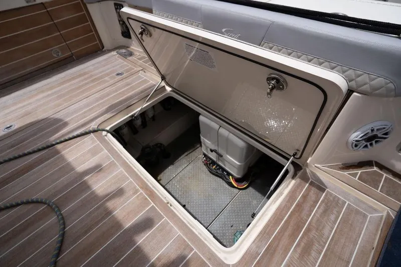 Slide: The Image of Open hatch on 2020 Scout 530 LXF boat deck, revealing storage compartment. - 129