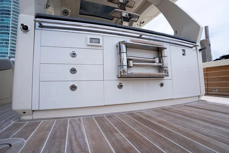 Slide: The Image of 2020 Scout 530 LXF yacht deck with sleek cabinetry and stainless steel grill. - 131