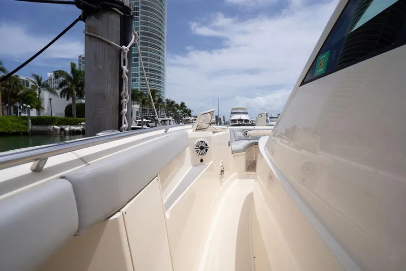Slide: The Image of 2020 Scout 530 LXF luxury yacht docked in a marina with modern architecture. - 133