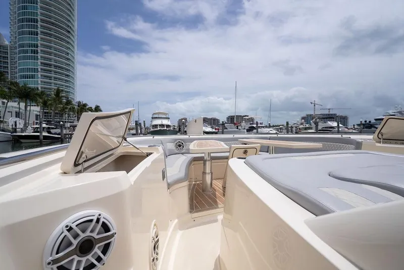 Slide: The Image of 2020 Scout 530 LXF luxury yacht docked at marina with cityscape background. - 134