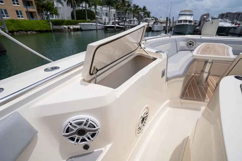Slide: The Image of 2020 Scout 530 LXF boat interior with open storage, speaker, and seating area. - 135