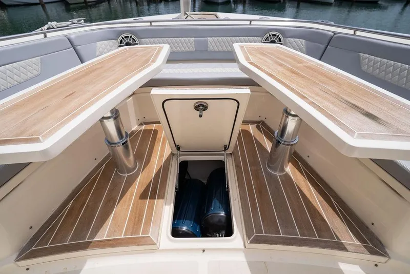 Slide: The Image of 2020 Scout 530 LXF boat interior with wooden tables and storage compartment. - 136