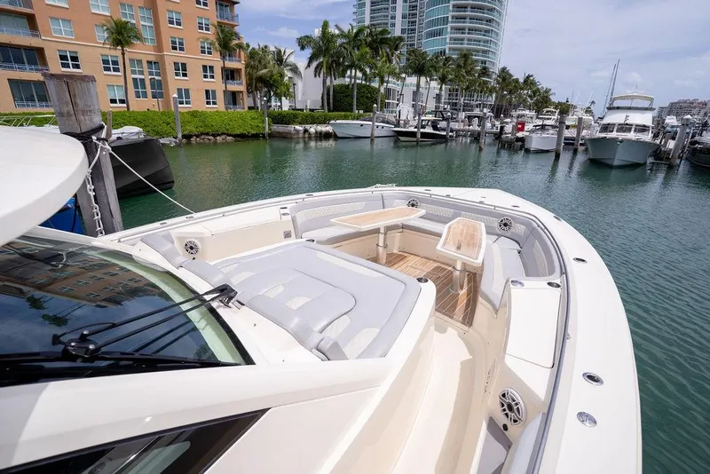 Slide: The Image of 2020 Scout 530 LXF luxury yacht docked in a marina with modern buildings. - 139
