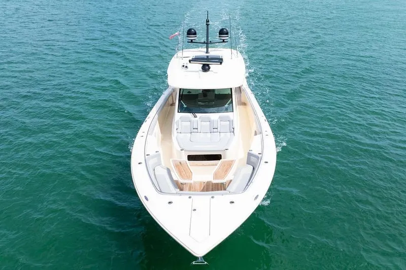 Slide: The Image of 2020 Scout 530 LXF luxury boat cruising on clear blue water. - 14