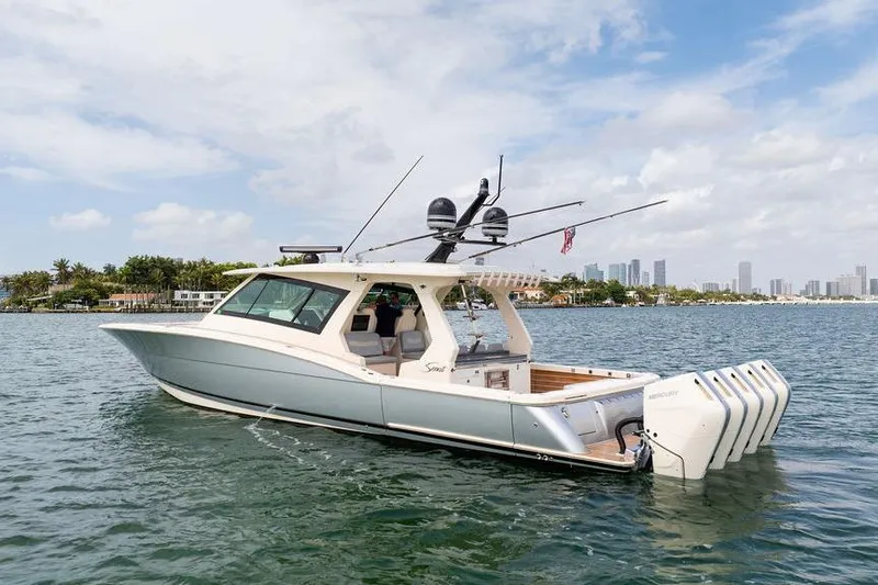 Slide: The Image of 2020 Scout 530 LXF luxury boat on water with city skyline background. - 17