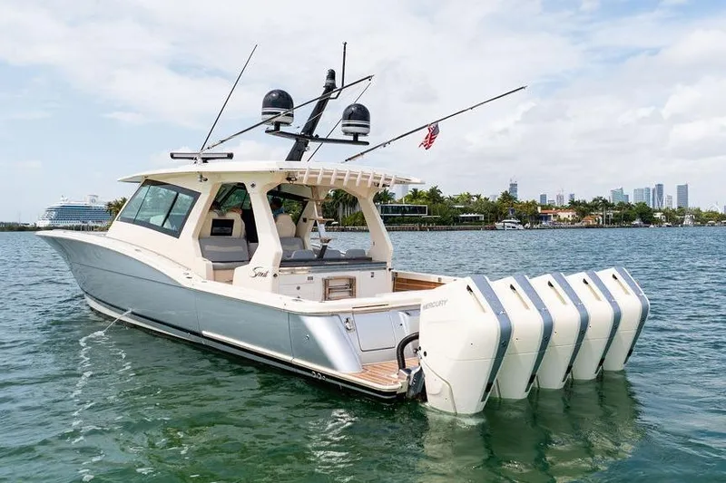 Slide: The Image of 2020 Scout 530 LXF luxury boat with multiple engines on a sunny day. - 18