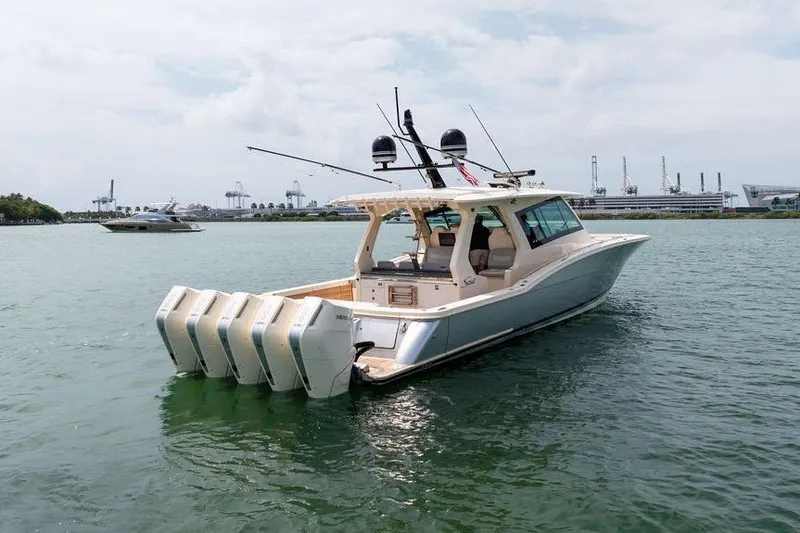 Slide: The Image of 2020 Scout 530 LXF boat with multiple engines on calm water. - 20