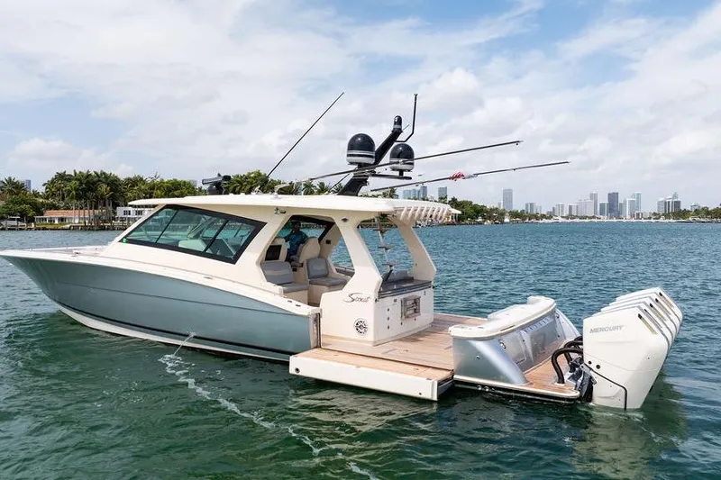 Slide: The Image of 2020 Scout 530 LXF luxury boat cruising on a scenic waterway. - 21