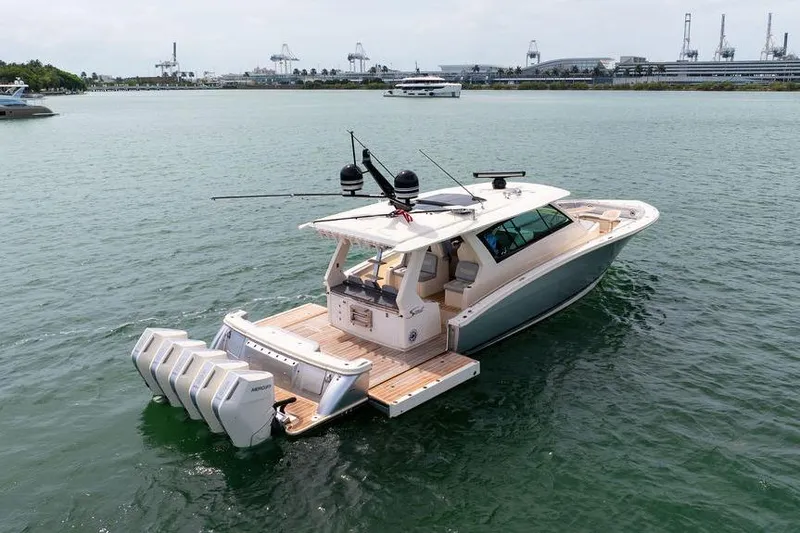 Slide: The Image of 2020 Scout 530 LXF luxury boat with multiple engines on calm water. - 22
