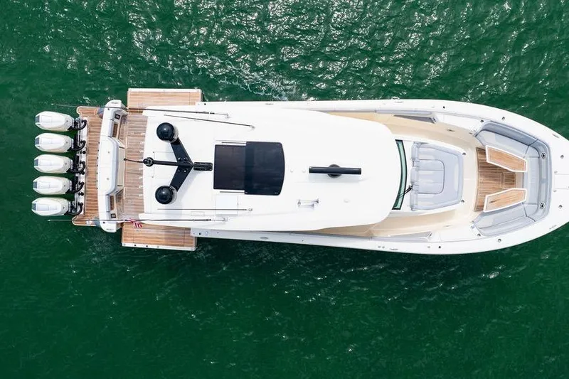 Slide: The Image of Aerial view of 2020 Scout 530 LXF luxury boat on green water. - 25