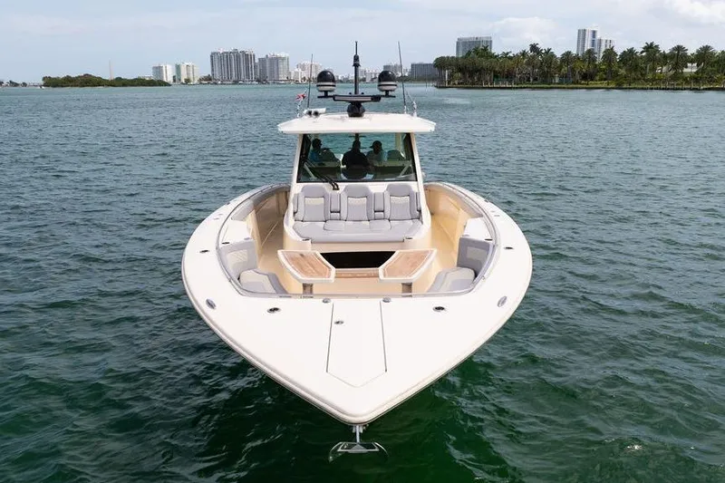 Slide: The Image of 2020 Scout 530 LXF luxury boat on water, city skyline in background. - 27