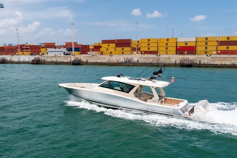 Slide: The Image of 2020 Scout 530 LXF yacht cruising near shipping containers in a harbor. - 31