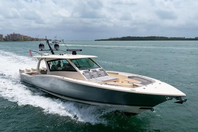 Slide: The Image of 2020 Scout 530 LXF luxury boat cruising on open water under cloudy skies. - 34