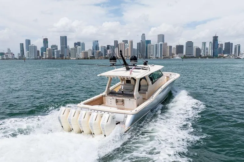 Slide: The Image of 2020 Scout 530 LXF boat cruising near city skyline on a sunny day. - 37